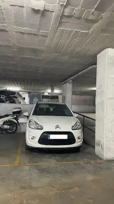 a white car parked in a parking garage at Apartamento en el centro urbano in Vilanova i la Geltrú