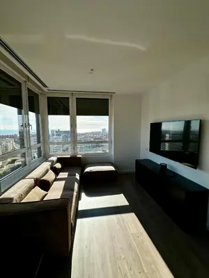 a large living room with a couch and a tv at The Olive in Barcelona