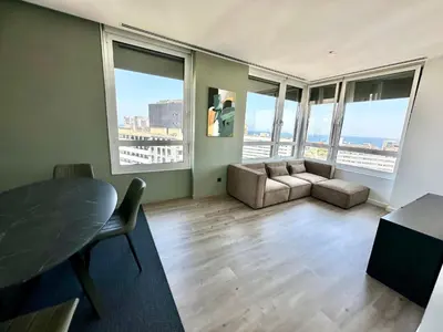 a living room with a couch and a table at The Olive in Barcelona