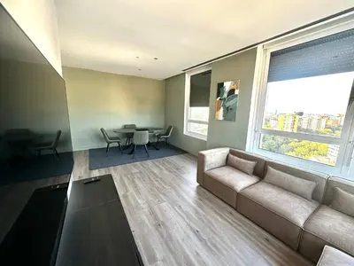 a living room with a couch and a table at The Olive in Barcelona