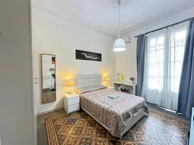 a bedroom with a bed and a mirror at Habitaciones Roger in Barcelona