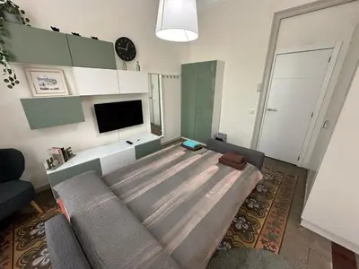 a living room with a couch and a flat screen tv at Habitaciones Roger in Barcelona