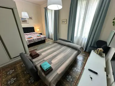 a living room with a couch and a bed at Habitaciones Roger in Barcelona
