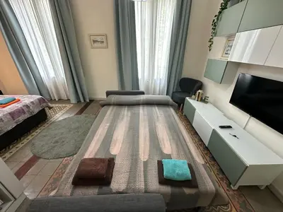 a living room with a couch and a flat screen tv at Habitaciones Roger in Barcelona