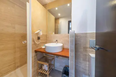 a bathroom with a sink and a toilet at AinB Born-Dames Apartments in Barcelona
