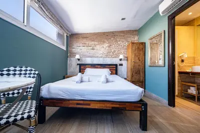 a bedroom with a bed in a room with blue walls at AinB Born-Dames Apartments in Barcelona