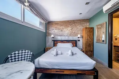 a bedroom with a bed and a table and chairs at AinB Born-Dames Apartments in Barcelona