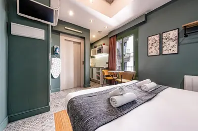 a bedroom with a bed with two towels on it at AinB Born-Dames Apartments in Barcelona