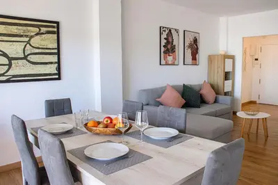 a dining room with a table and a couch at Apartments BCN Central-Colon in Barcelona