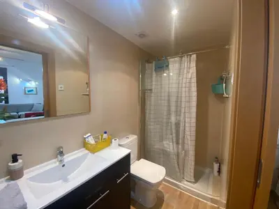 a bathroom with a sink and a toilet and a shower at Long Stays Terrassa Near Center in Terrassa