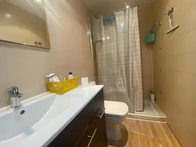 a bathroom with a sink and a toilet and a shower at Long Stays Terrassa Near Center in Terrassa