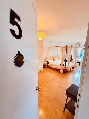 a room with a bed and a number on the door at Casa Clot in Barcelona