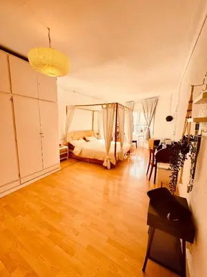 a bedroom with a bed and a table in a room at Casa Clot in Barcelona