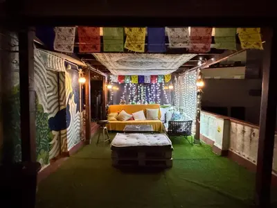 a living room with a couch in a room with lights at Casa Clot in Barcelona