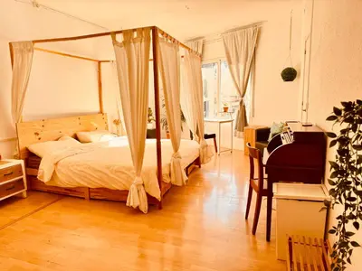 a bedroom with a canopy bed and a desk at Casa Clot in Barcelona