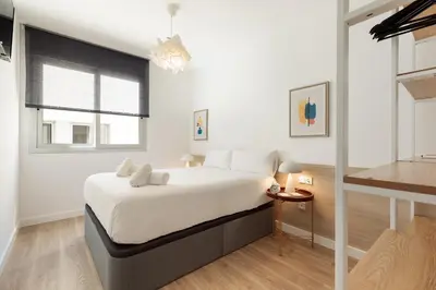 a bedroom with a large bed and a window at Ola Living Poblenou Beach in Barcelona