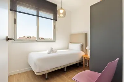 a bedroom with a white bed and a window at Ola Living Poblenou Beach in Barcelona