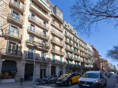 a tall building with cars parked in front of it at RentBCN Rambla Catalunya Apartment in Barcelona