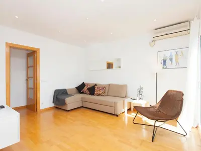 a living room with a couch and a chair at RentBCN Rambla Catalunya Apartment in Barcelona