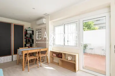 a dining room with a table and a window at Vacation house with garden in the foothills in Barcelona