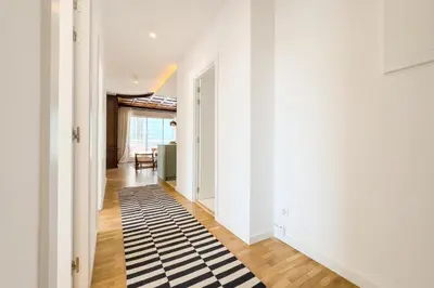 a hallway with a black and white rug on the floor at Sagrada in Barcelona