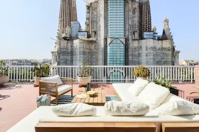 a balcony with a white couch and a building at Sagrada in Barcelona