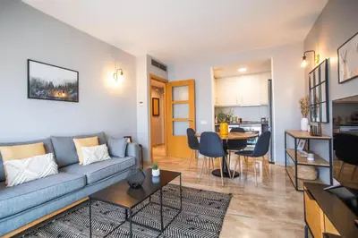 a living room with a couch and a dining room at 13MAL1077- Magnific 2BR flat in Barcelona