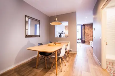 a dining room with a wooden table and chairs at B3MAL1081- New 2BR flat with private terrace in Barcelona