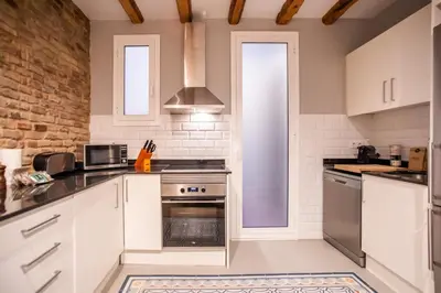 a kitchen with white appliances and a brick wall at B3MAL1081- New 2BR flat with private terrace in Barcelona