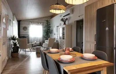 a kitchen and dining room with a table and chairs at Hogar con encanto y personalidad in L'Ametlla del Vallès