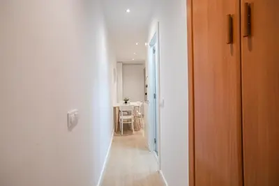 a hallway leading to a dining room with a table at E4lle1031 - Studio next to Plaza Espanya in Barcelona