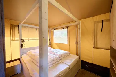 a kitchen with a long wooden table in a room at Glamping Costa Dorada in Vilanova i la Geltrú