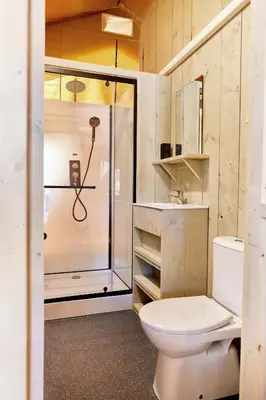 a bathroom with a toilet and a shower at Glamping Costa Dorada in Vilanova i la Geltrú