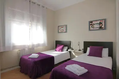 two beds in a room with purple and white at Classbedroom Barcelona Sagrera Apartment in Barcelona