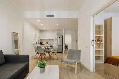 a living room with a table and a couch at Ola Living Sant Antoni Market in Barcelona