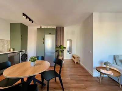 a kitchen and dining room with a table and chairs at Ola Living Sant Antoni Market in Barcelona