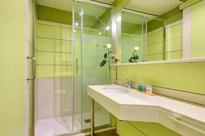a bathroom with a glass shower and a sink at Bonanova Suite in Barcelona