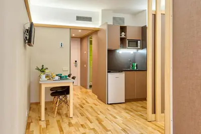 a small apartment with a table and a kitchen at Bonanova Suite in Barcelona
