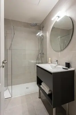 a bathroom with a sink and a shower at Serra house premium apartments in Barcelona