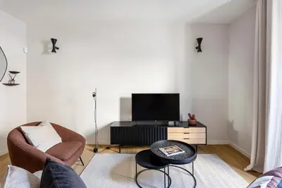 a living room with a tv and a couch and a table at Serra house premium apartments in Barcelona