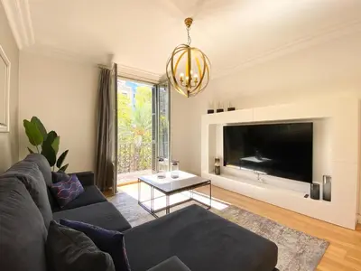 a living room with a couch and a large tv at Spacious Elegant on Avenue Diagonal By MyRentalHost in Barcelona
