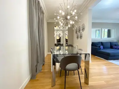 a dining room with a table and a blue couch at Spacious Elegant on Avenue Diagonal By MyRentalHost in Barcelona
