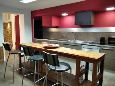 a kitchen with a wooden table and chairs at ApartEasy - MONUMENT, large, cosy apartment in Barcelona