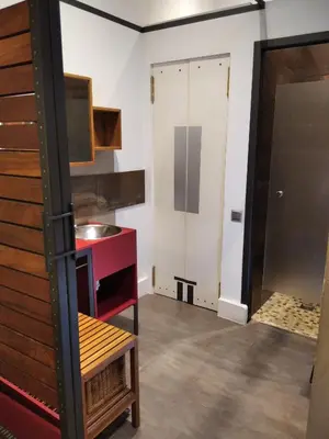 a kitchen with a sink and a red counter at ApartEasy - MONUMENT, large, cosy apartment in Barcelona