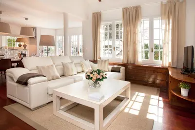 a living room with a white couch and a table at Villa Gaudi in San Justo Desvern