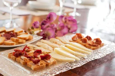 a table with a plate of cheese and waffles and bread at Villa Gaudi in San Justo Desvern