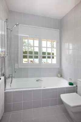 a white bathroom with a tub and a toilet at Villa Gaudi in San Justo Desvern