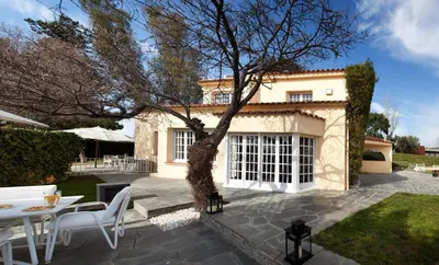 a patio with a table and chairs in front of a house at Villa Gaudi in San Justo Desvern