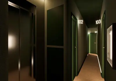a hallway with green and black walls and doors at BYPILLOW Twenty in Barcelona