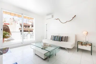 a living room with a white couch and a glass table at Viva Sitges - Mayo Terrace in Sitges